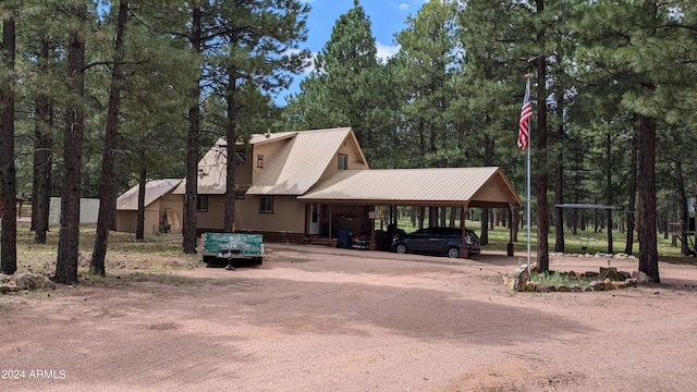 702 Mule Springs Trl, Forest Lakes, AZ 85931 - view of front facade featuring metal roof, dirt driveway, and view of wooded area
