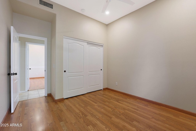 unfurnished bedroom with light hardwood / wood-style floors and a closet