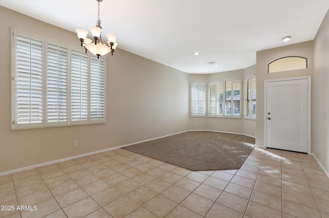 tiled entryway featuring an inviting chandelier