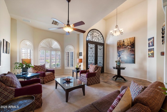 1922 E Everett Dr, Phoenix, AZ 85022 - living room with a high ceiling, baseboards, a ceiling fan, and a chandelier