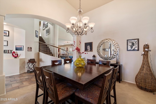 1922 E Everett Dr, Phoenix, AZ 85022 - dining area featuring stairway, high vaulted ceiling, arched walkways, a chandelier, and baseboards
