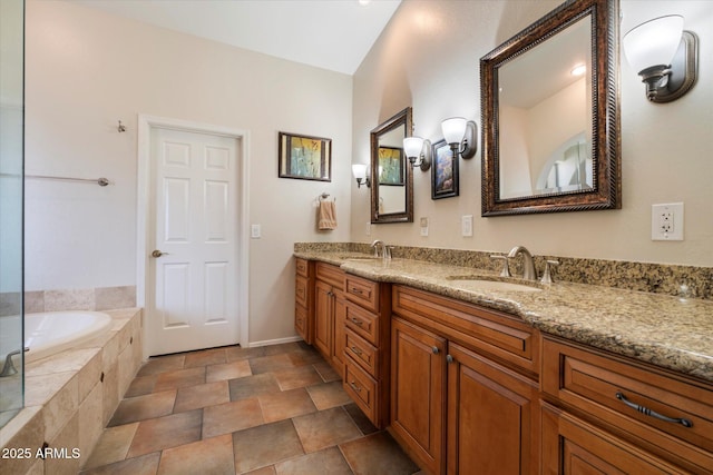1922 E Everett Dr, Phoenix, AZ 85022 - bathroom featuring double vanity, a bath, stone finish floors, and baseboards