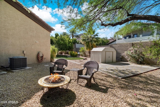1922 E Everett Dr, Phoenix, AZ 85022 - view of patio / terrace featuring a shed, an outdoor fire pit, an outdoor structure, a fenced backyard, and central air condition unit