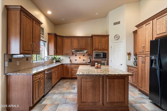 1922 E Everett Dr, Phoenix, AZ 85022 - kitchen featuring appliances with stainless steel finishes, a sink, under cabinet range hood, a kitchen island, and decorative backsplash
