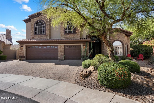 1922 E Everett Dr, Phoenix, AZ 85022 - view of front facade with decorative driveway, a garage, stone siding, stucco siding, and a tiled roof