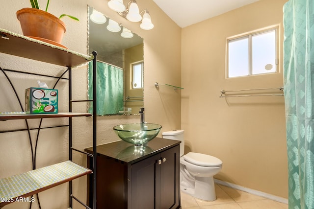 bathroom featuring tile patterned flooring, vanity, and toilet