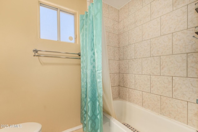 bathroom with shower / bath combination with curtain and toilet