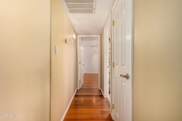 corridor featuring dark hardwood / wood-style flooring