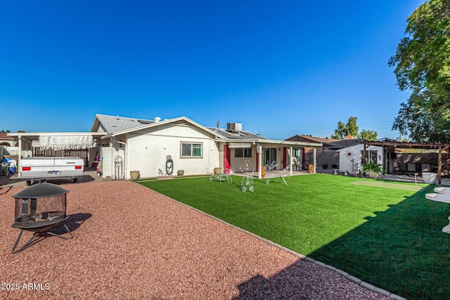 rear view of property featuring a yard and a patio