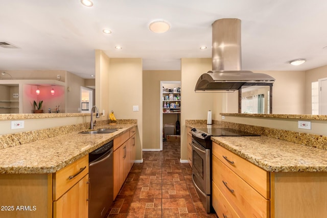 kitchen featuring sink, light stone counters, kitchen peninsula, island exhaust hood, and stainless steel appliances