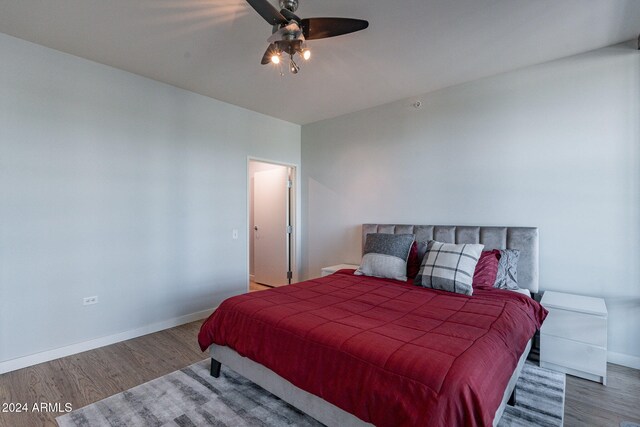 bedroom with wood-type flooring and ceiling fan