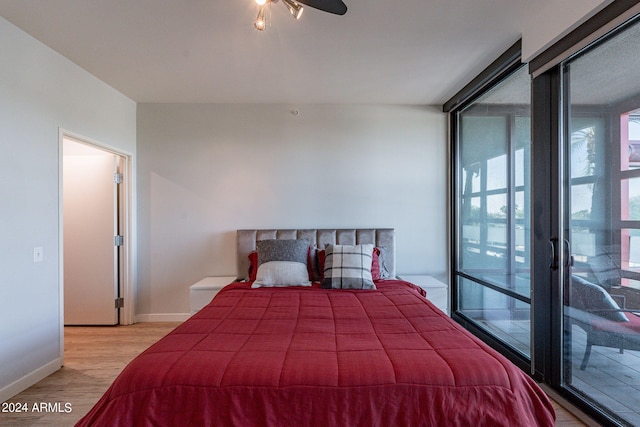 bedroom with light hardwood / wood-style floors and access to outside