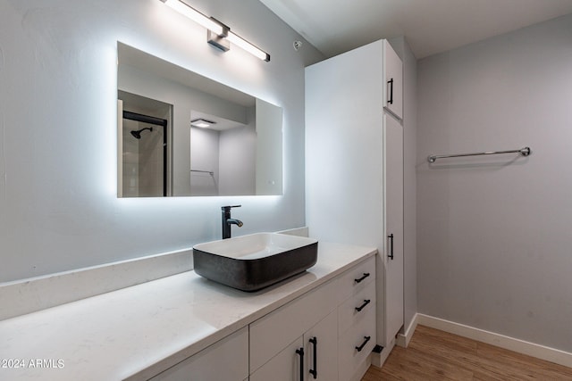 bathroom with vanity, hardwood / wood-style floors, and walk in shower