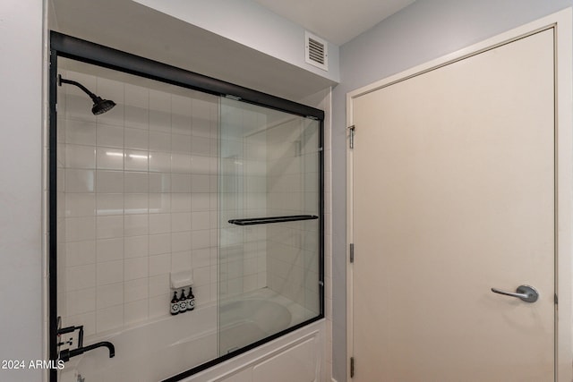 bathroom with shower / bath combination with glass door