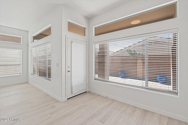 interior space featuring light wood-style flooring and baseboards