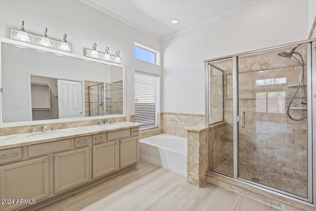 full bathroom with crown molding, a sink, a bath, and a shower stall