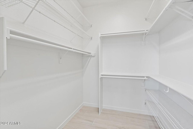 walk in closet featuring wood tiled floor