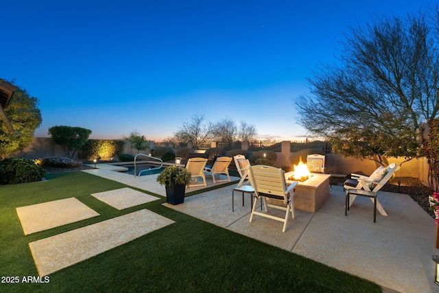 view of patio / terrace with a fenced backyard, a fire pit, and a fenced in pool