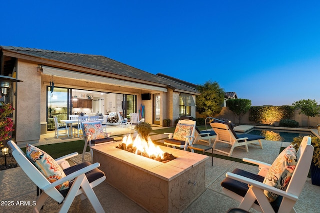 view of patio / terrace featuring fence and a fire pit