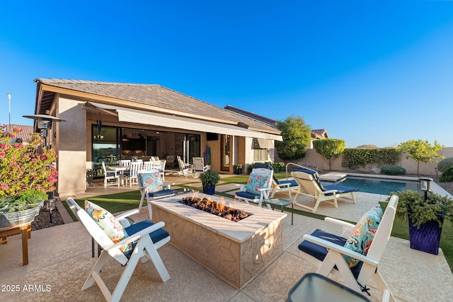 view of patio featuring a fenced backyard, a fire pit, and a fenced in pool