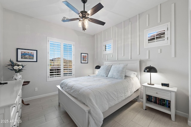 bedroom with visible vents, baseboards, and ceiling fan