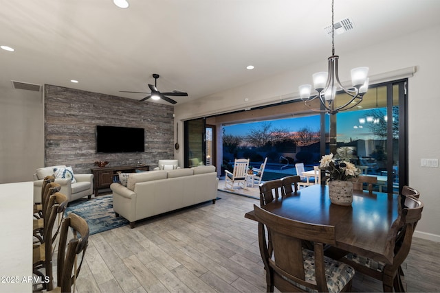 dining space with ceiling fan with notable chandelier, light wood-type flooring, visible vents, and recessed lighting