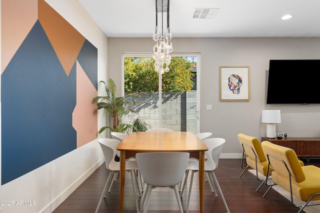 dining area with visible vents, dark wood finished floors, a notable chandelier, and baseboards