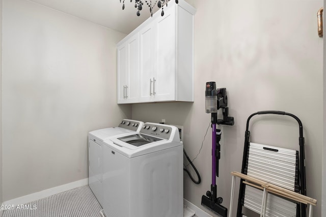 laundry area with cabinet space, light tile patterned floors, baseboards, and independent washer and dryer