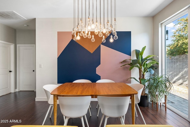 dining room with dark wood-style floors, a chandelier, visible vents, and baseboards