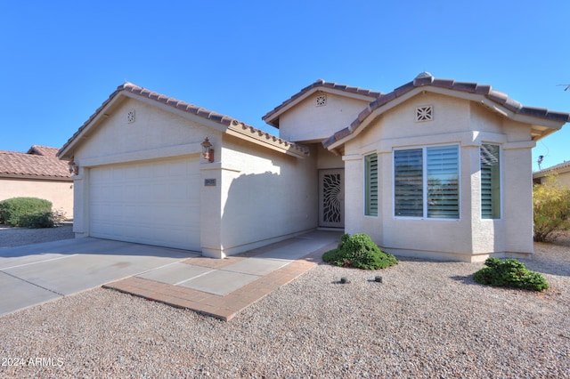 view of front of home featuring stucco siding, concrete driveway, and a garage