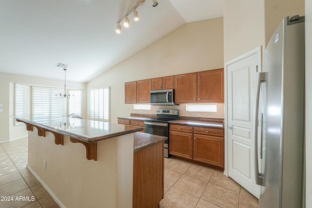 kitchen featuring light tile patterned floors, brown cabinets, and appliances with stainless steel finishes