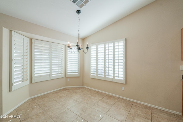 tiled spare room with vaulted ceiling, a notable chandelier, baseboards, and visible vents