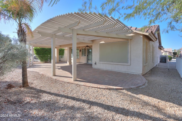 rear view of house with a patio, fence, a pergola, stucco siding, and a tiled roof