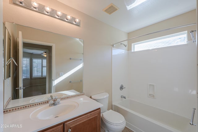 bathroom featuring visible vents, toilet,  shower combination, and vanity