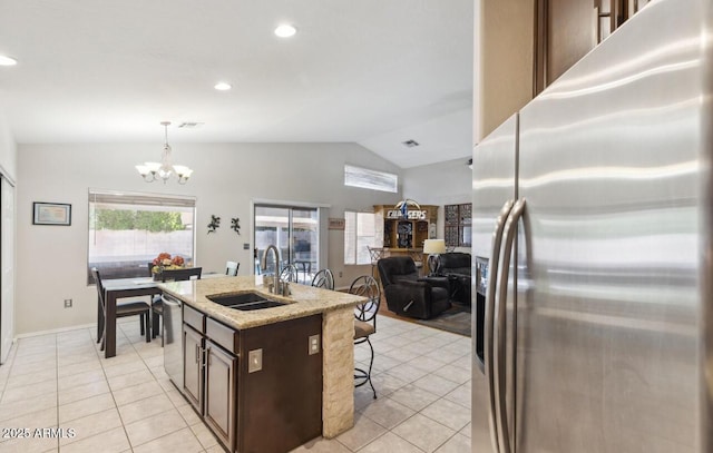 7457 W Crystal Rd, Glendale, AZ 85308 - kitchen featuring a sink, vaulted ceiling, light tile patterned floors, a notable chandelier, and appliances with stainless steel finishes