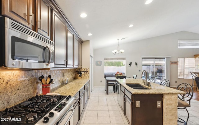 7457 W Crystal Rd, Glendale, AZ 85308 - kitchen featuring a kitchen bar, a sink, stainless steel appliances, a notable chandelier, and lofted ceiling