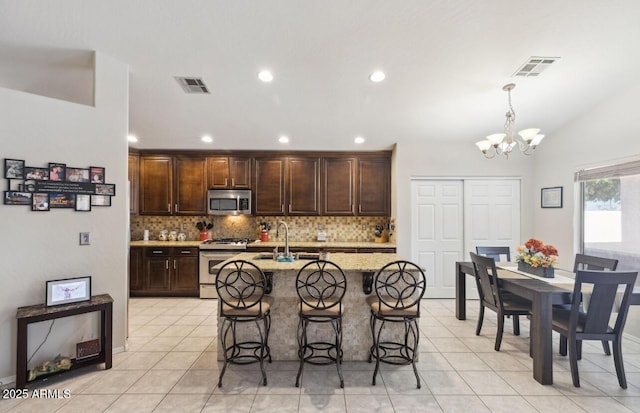 7457 W Crystal Rd, Glendale, AZ 85308 - kitchen with backsplash, a notable chandelier, visible vents, and appliances with stainless steel finishes