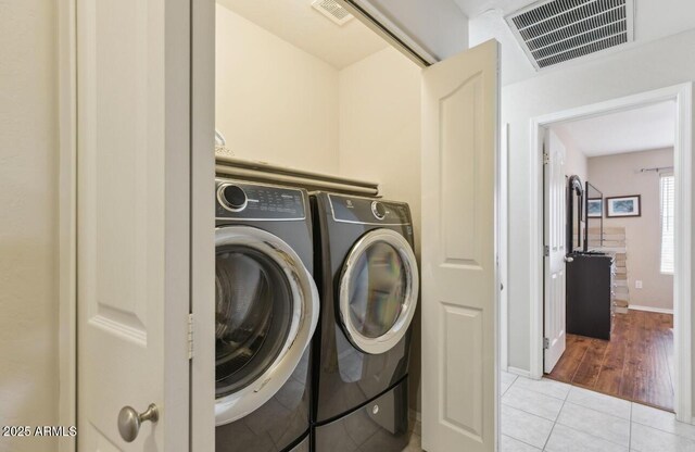 7457 W Crystal Rd, Glendale, AZ 85308 - laundry area featuring washer and dryer, laundry area, visible vents, baseboards, and light tile patterned flooring