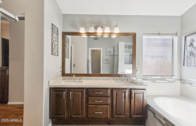 7457 W Crystal Rd, Glendale, AZ 85308 - full bath with a sink, double vanity, a garden tub, and visible vents