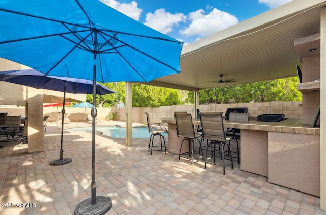 7457 W Crystal Rd, Glendale, AZ 85308 - view of patio with an outdoor bar, a fenced in pool, and a fenced backyard