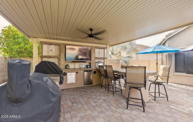 7457 W Crystal Rd, Glendale, AZ 85308 - view of patio featuring a fenced backyard, ceiling fan, area for grilling, and exterior kitchen