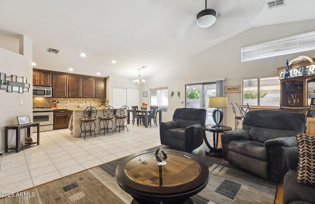 7457 W Crystal Rd, Glendale, AZ 85308 - living room with ceiling fan with notable chandelier, light tile patterned floors, visible vents, and recessed lighting