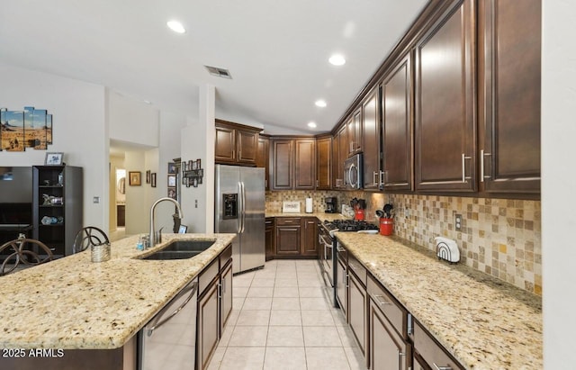 7457 W Crystal Rd, Glendale, AZ 85308 - kitchen featuring light stone countertops, visible vents, a sink, backsplash, and appliances with stainless steel finishes