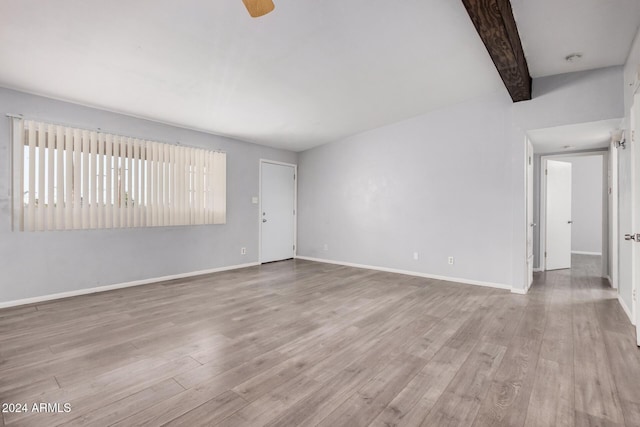 spare room featuring beam ceiling, ceiling fan, and light hardwood / wood-style floors