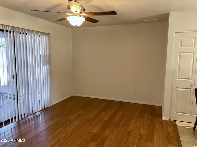 unfurnished room with hardwood / wood-style flooring and ceiling fan