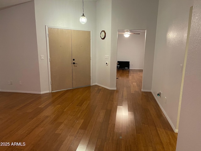 entrance foyer featuring hardwood / wood-style flooring, ceiling fan, and a high ceiling