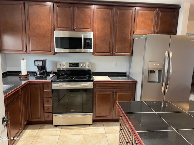 kitchen with stainless steel appliances and light tile patterned floors