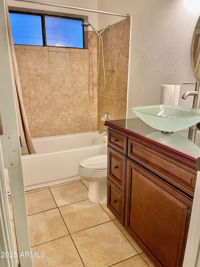 full bathroom featuring vanity, tile patterned floors, shower / bath combo with shower curtain, and toilet