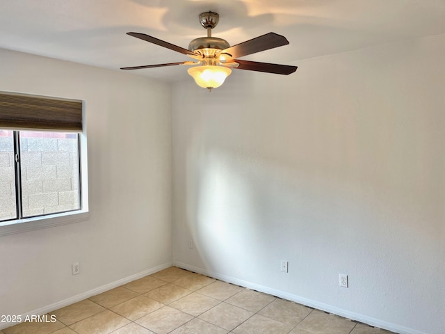 tiled empty room featuring ceiling fan