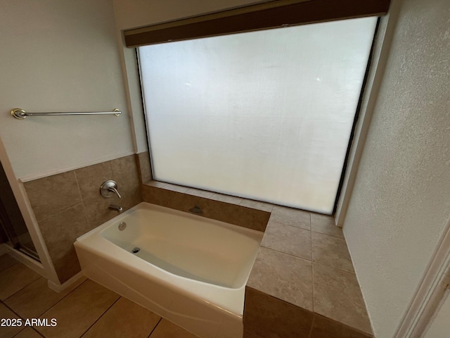 bathroom featuring tile patterned floors and a bathtub